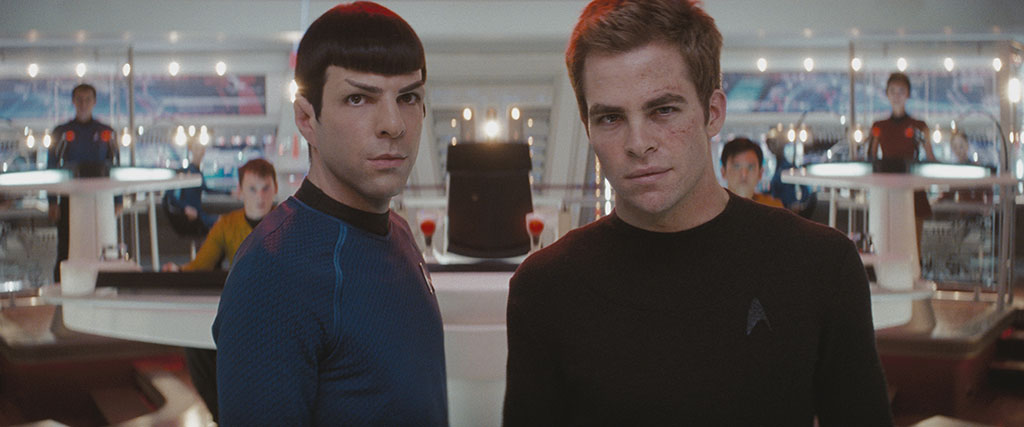 Spock and Kirk stand on the bridge of a spacecraft.
