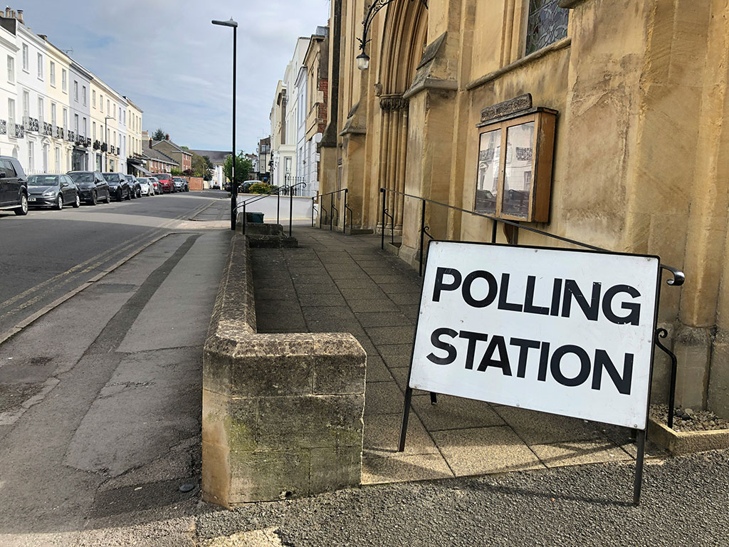 A sign reading 'polling station' stands by the entrance to a church.