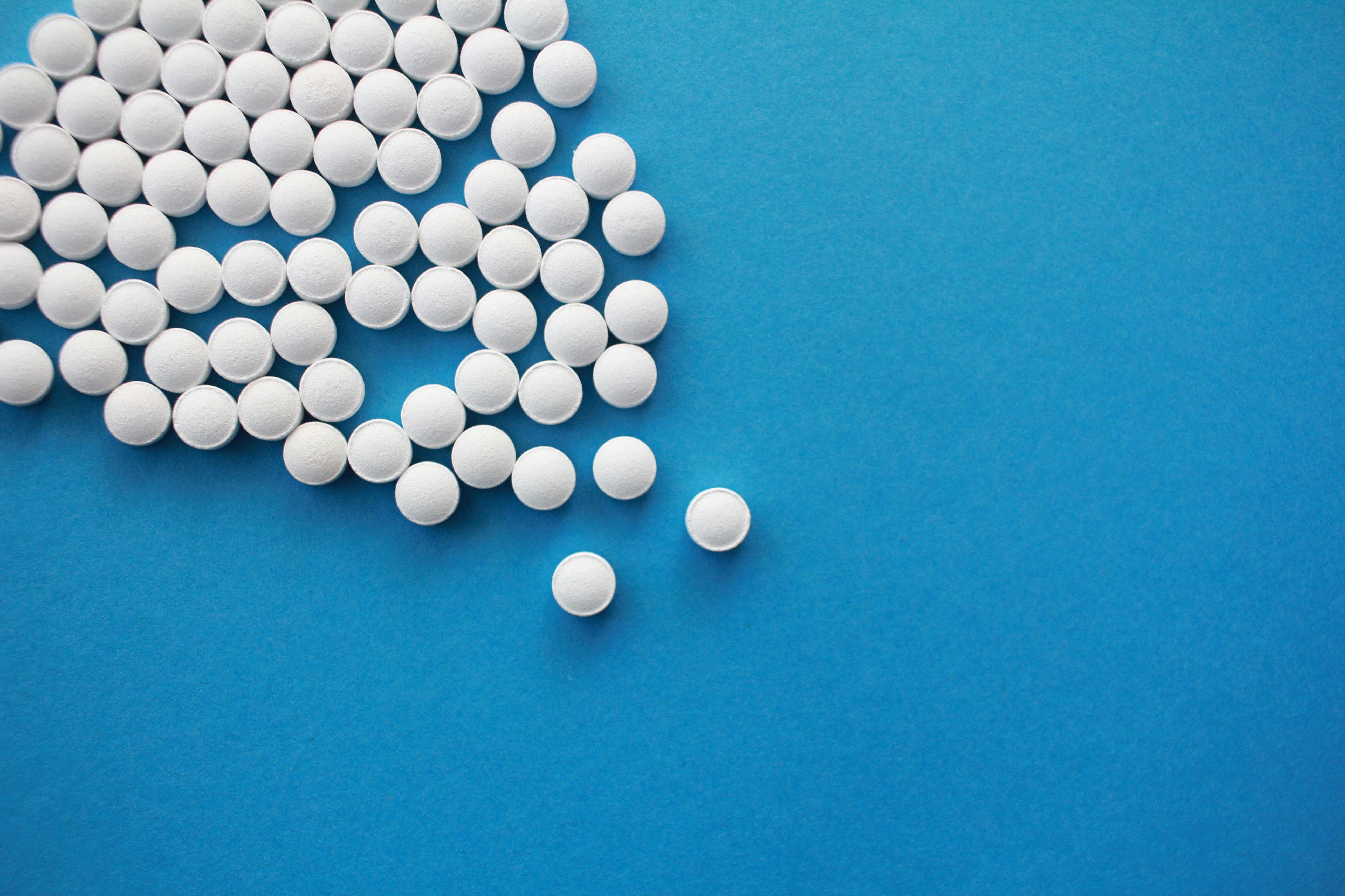 white pills form an angle on a blue background