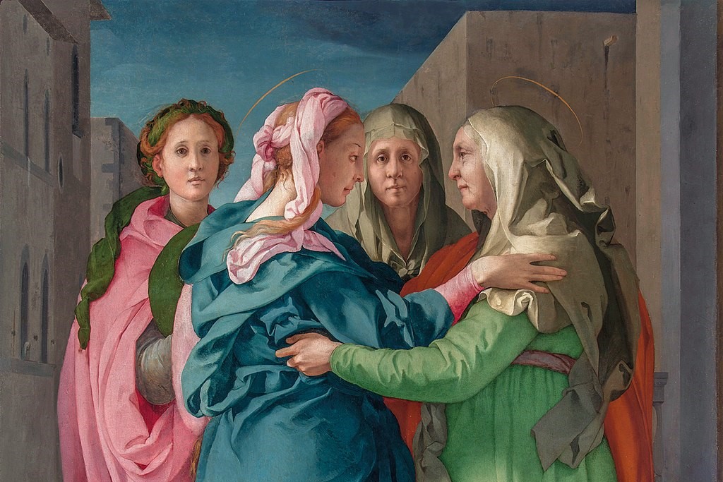 A Renaissance painting of Elizabeth greeting the Virgin birth show two woman reaching out to hug, while others look on.