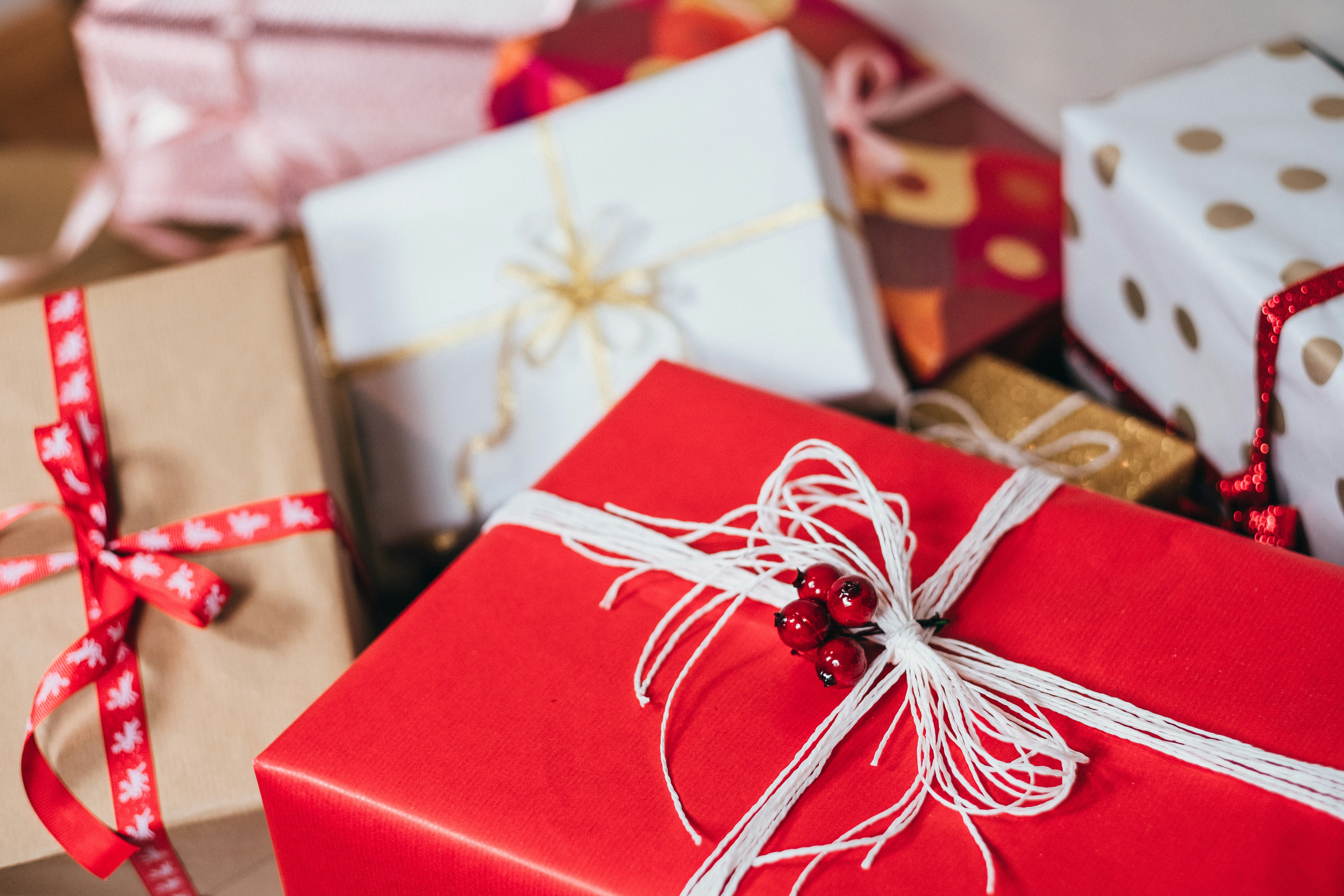 Christmas presents wrapped with red and white paper and string.