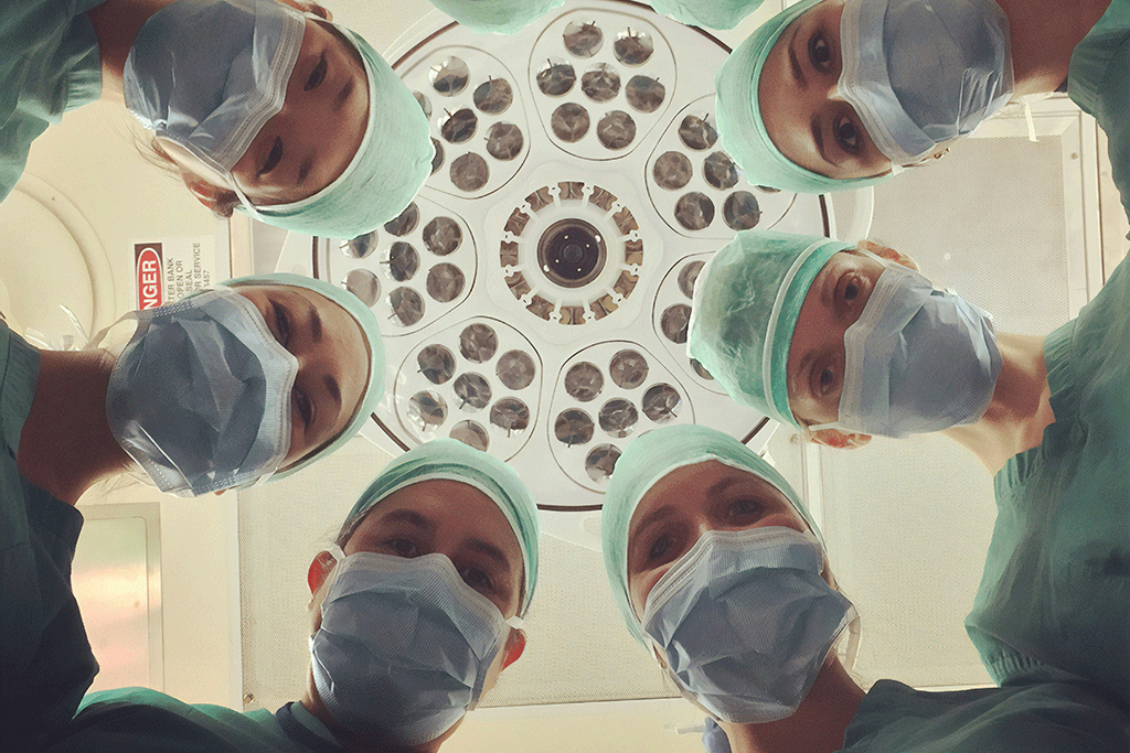 A patient eye view of six surgeons looking down.