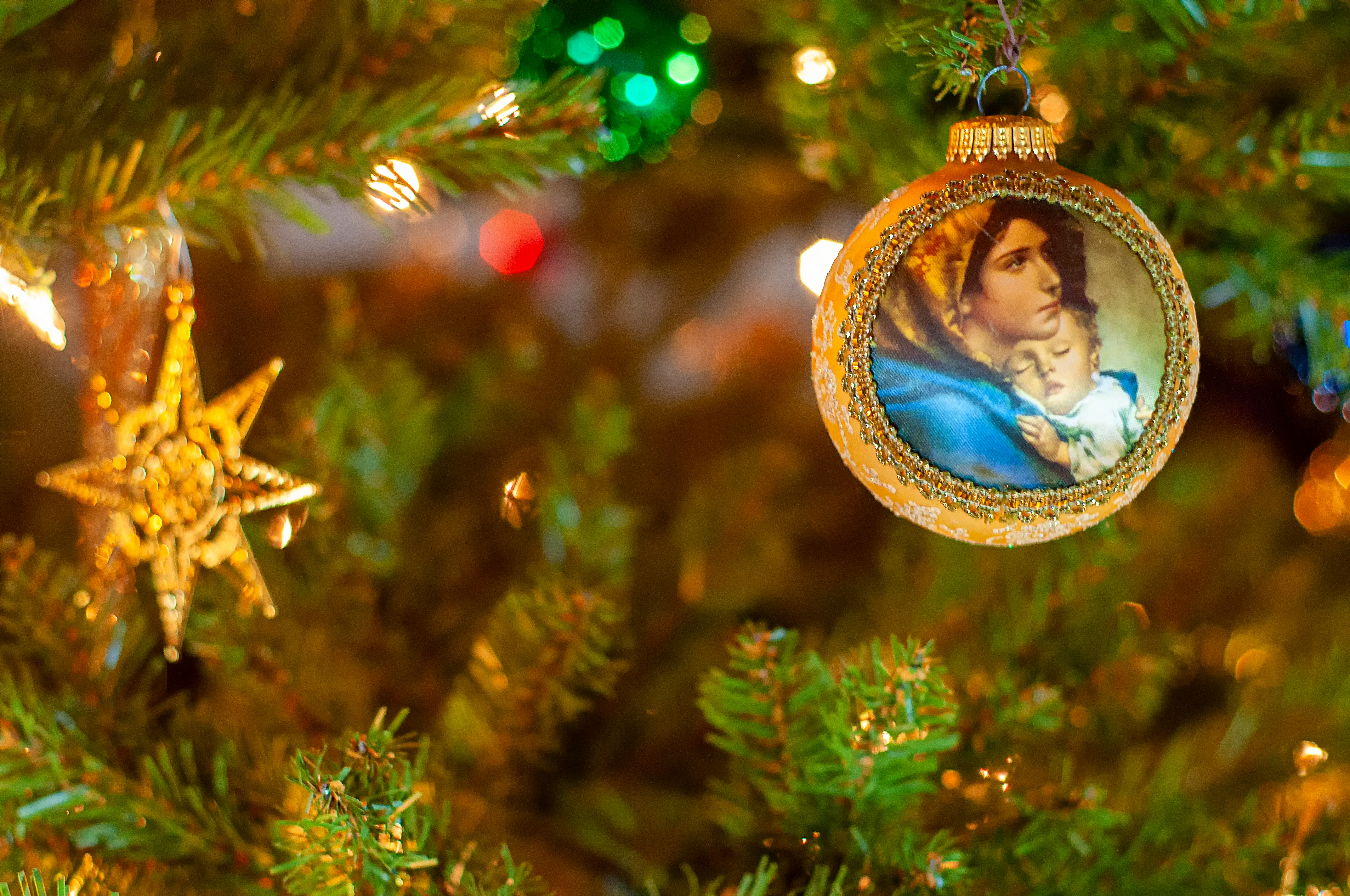 A Christmas tree bauble depicts the Virgin and Child.