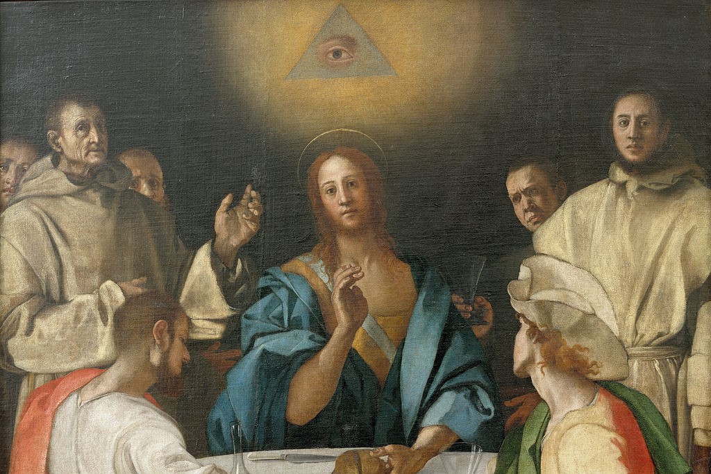 an all seeing eye hovers above a renaissance style picture of the supper at Emmaus.