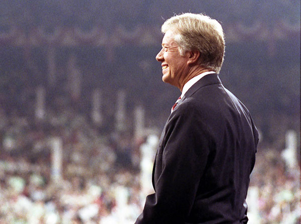 Jimmy Cater stands on a convention stage looking out over the crowd.