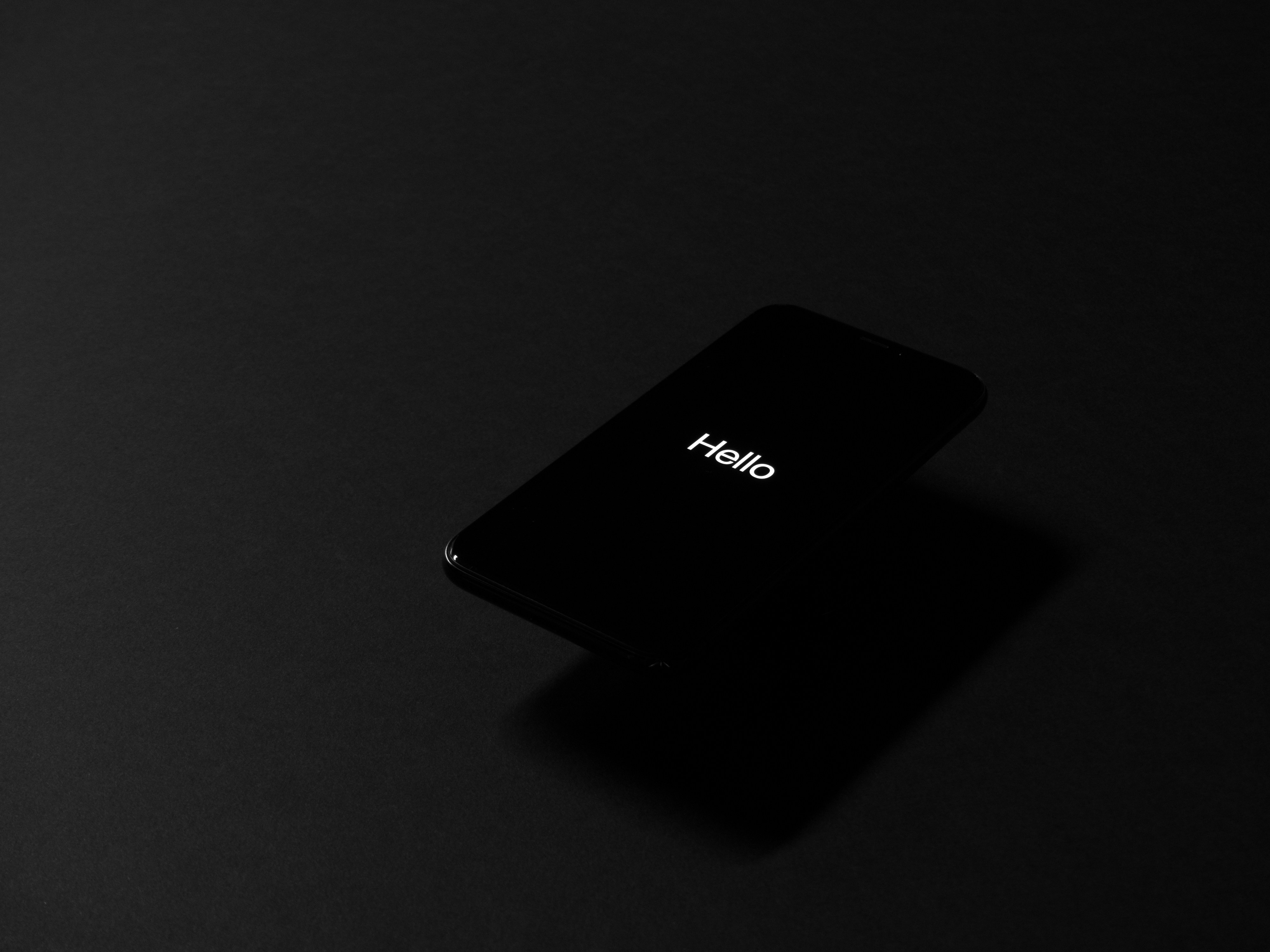 A dark image shows a dark screen with the tiny word 'hello' on it.