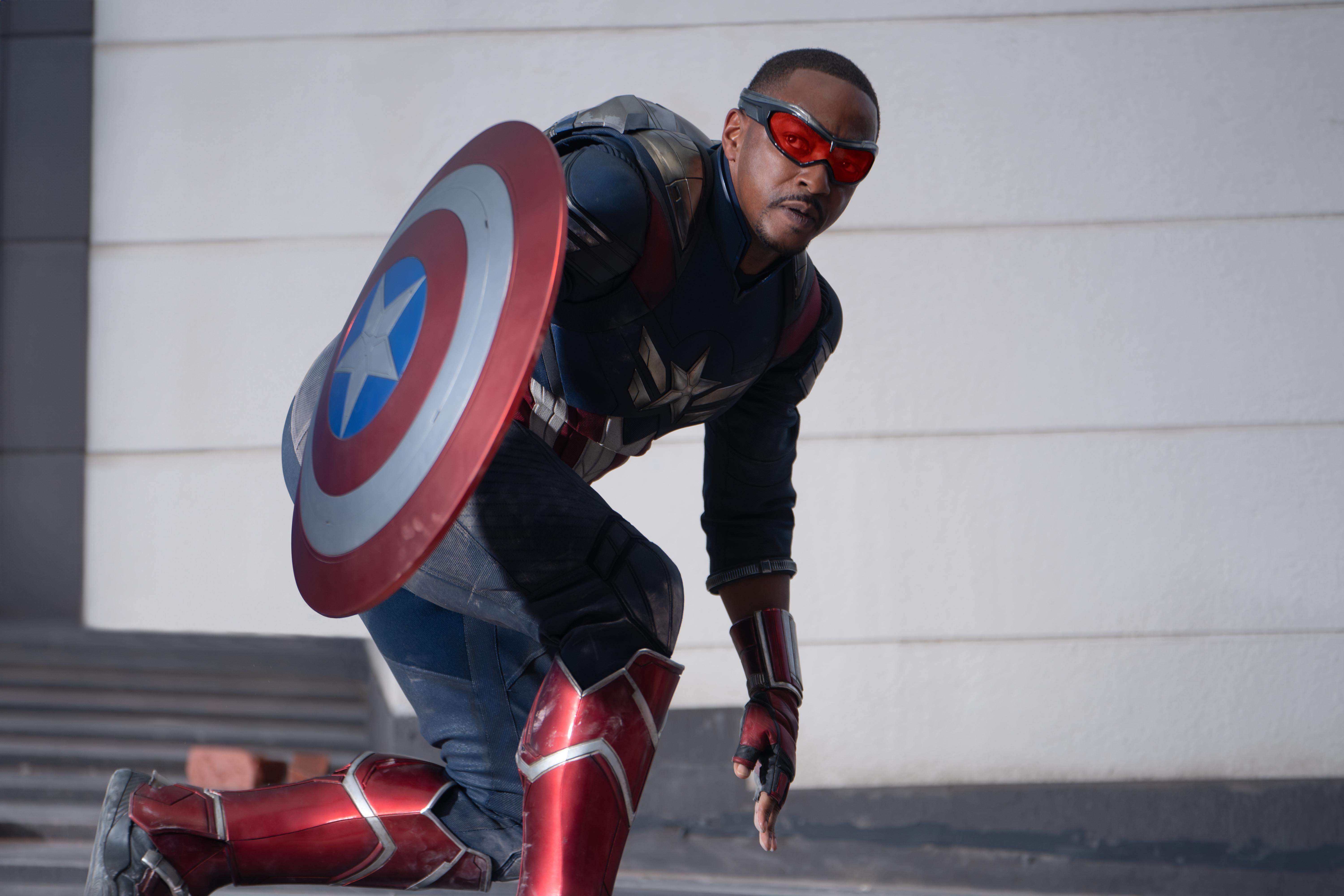 Captain America crouches expectantly beside his shield