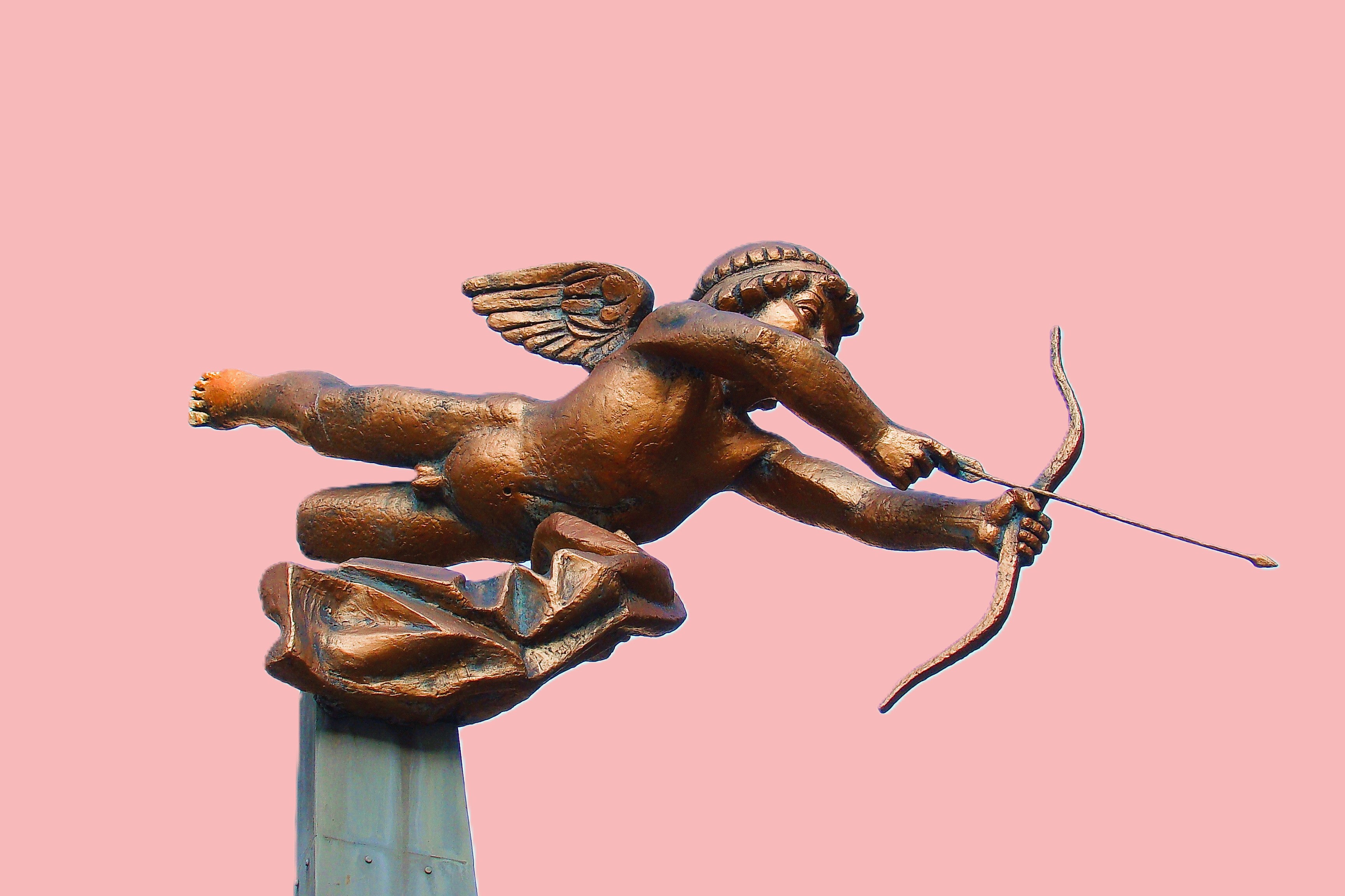 A cupid statue fires an arrow of love.