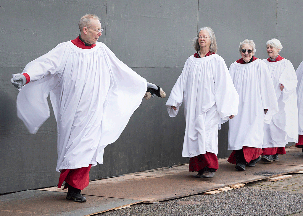 Clergy process as they are filmed for a projecton.