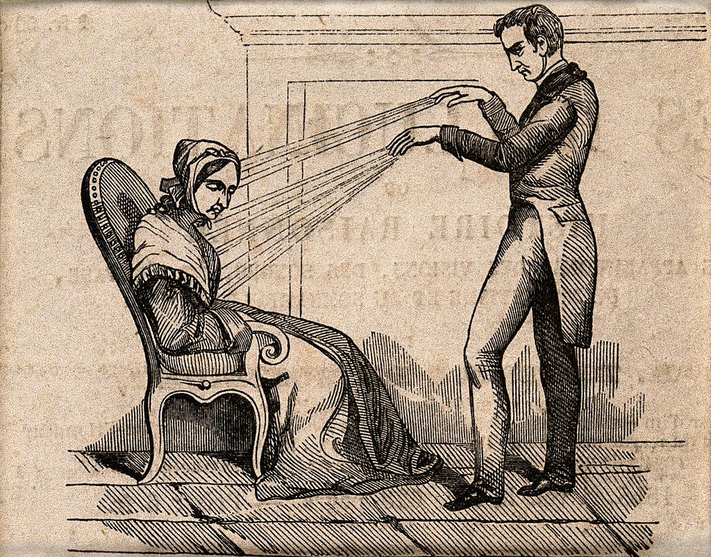 An engraving of  shows a standing mesmerist pointing to a sitting patient, with lines drawn between the,