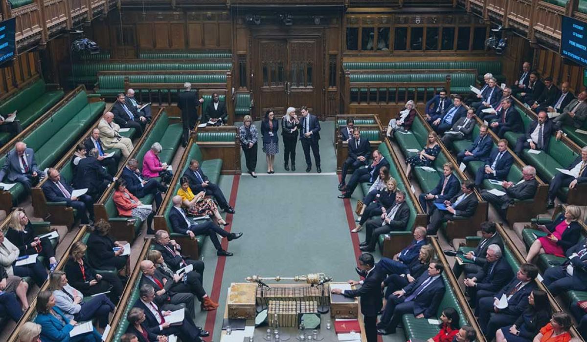 an aerial view down in to the parliamentary chamber shows MPs sitting on benches on the left and right hand side