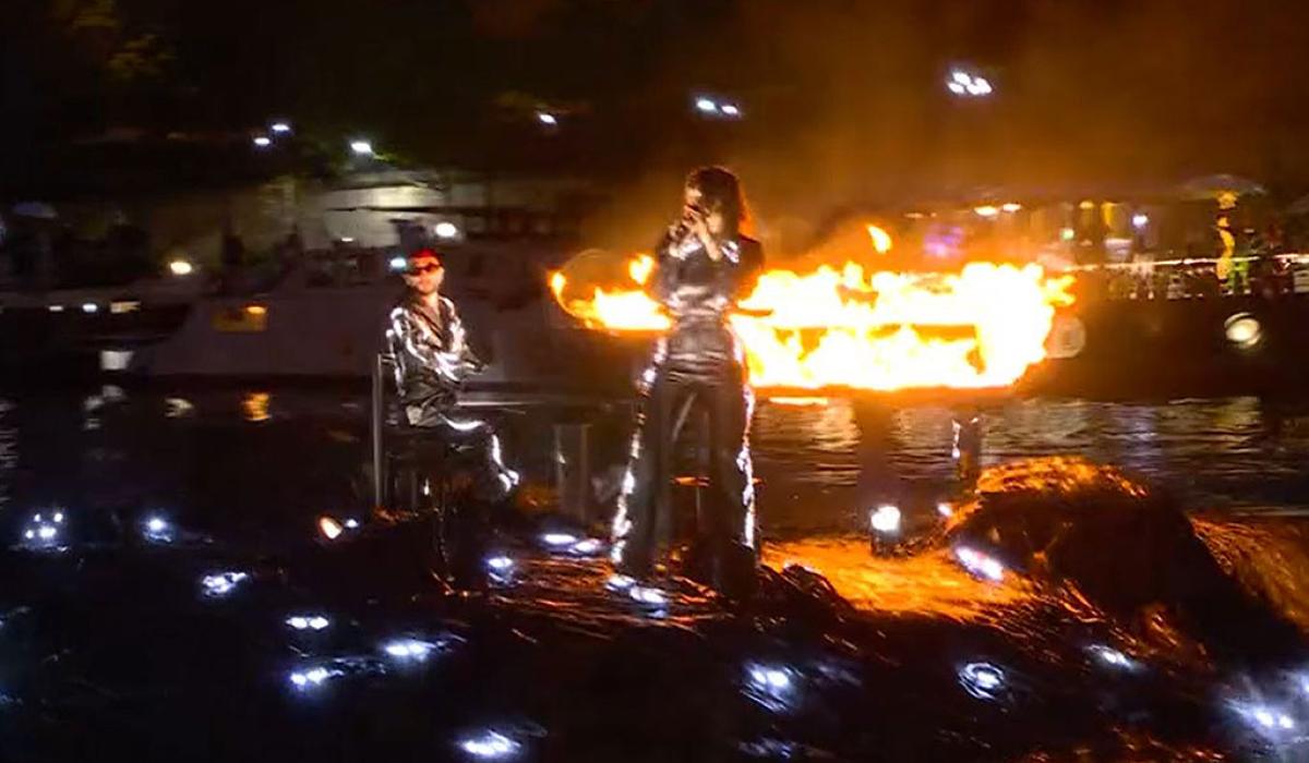 A floating stage bears a flaming piano and singer standing at a mic.