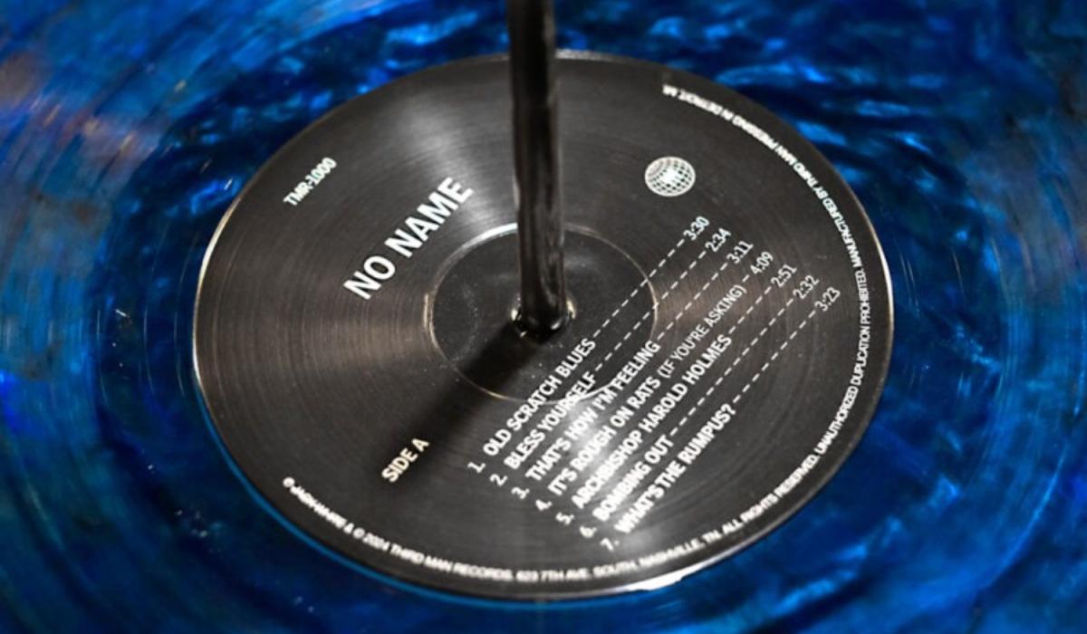 A close-up of the black label of a blue vinyl record