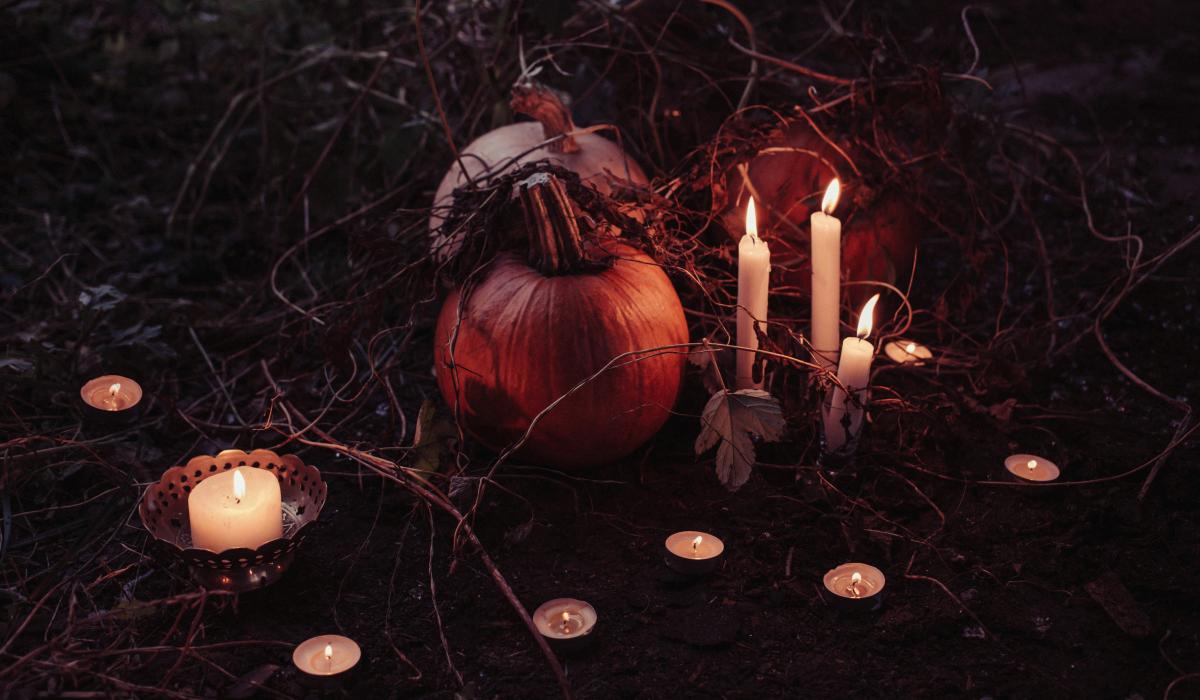 pumpkin between lighted candles