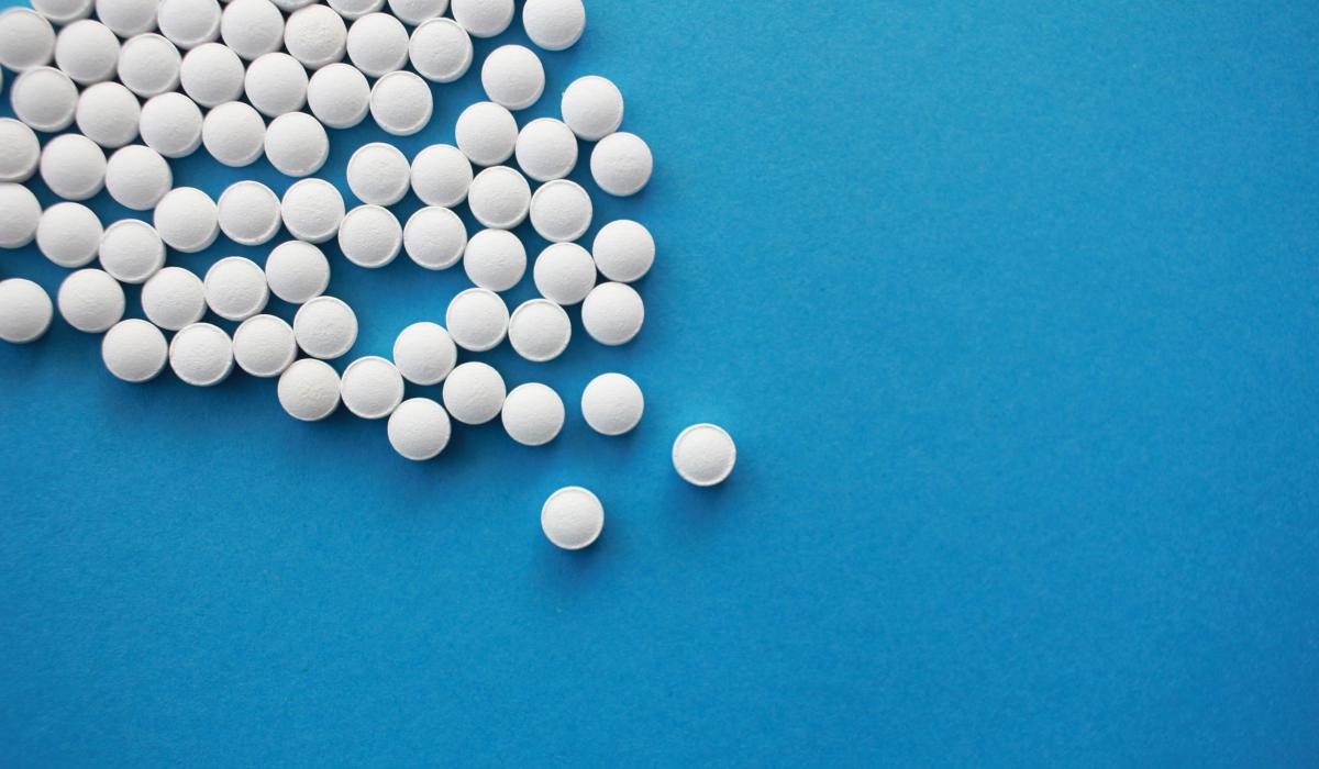 white pills form an angle on a blue background