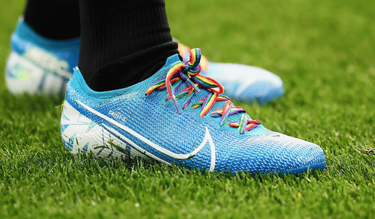 A football boot with rainbow laces