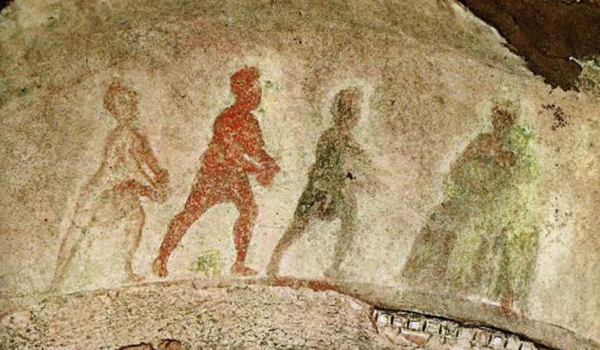 Silhouttes of three wise men approach the Virgin and Child, painted on stone. 