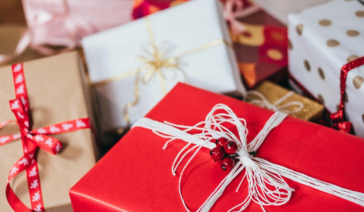 Christmas presents wrapped with red and white paper and string.