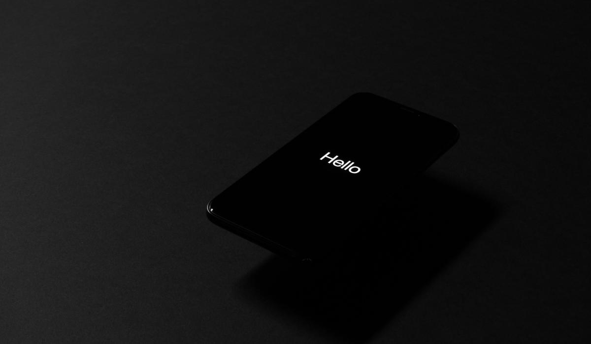 A dark image shows a dark screen with the tiny word 'hello' on it.