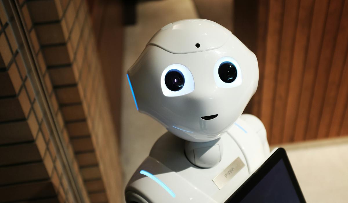 A cute-looking robot with big eyes stares up at the viewer.