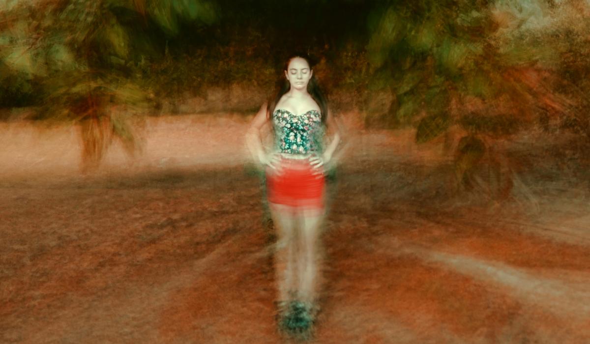 A montage image places a woman, with eyes shut and hands on hip, at the centre of blurred circle of ground and tree branches.