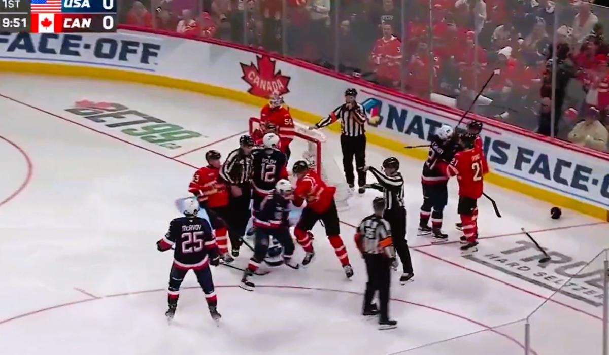 Ice hockey players fight in front of a goal