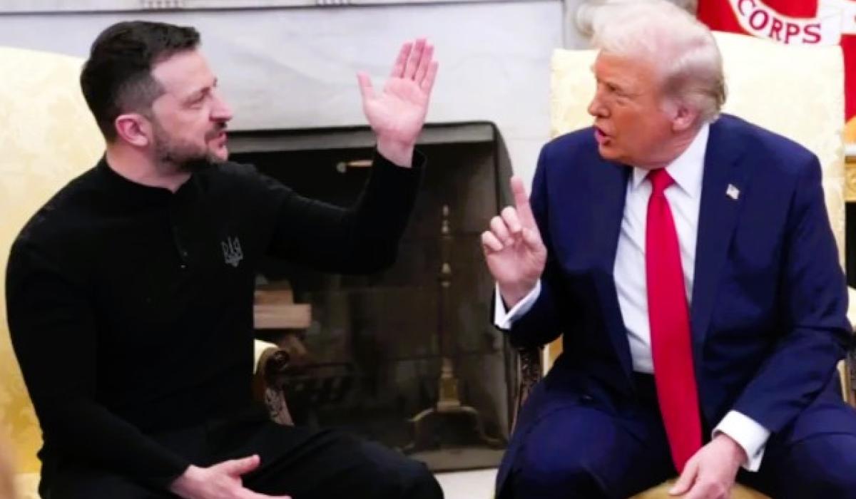 President Zelensky raises a hand while President Trump talks at him.