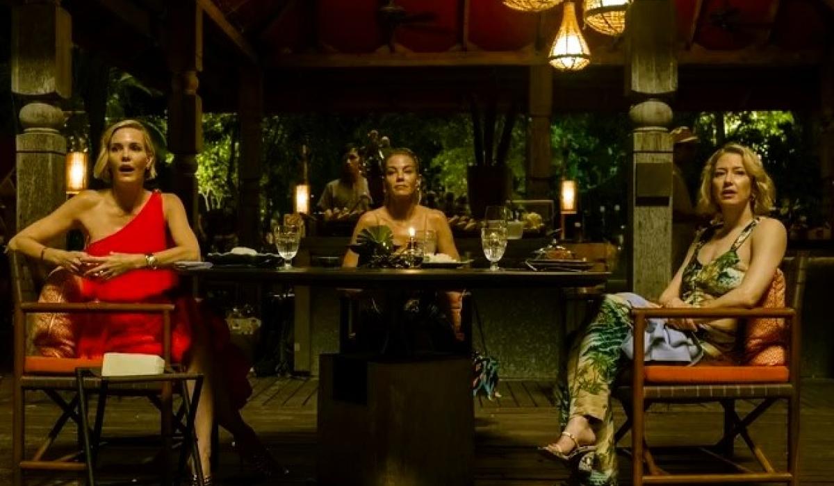 Three woman dining in a luxury hotel in Thailand, turn and look to the camera.