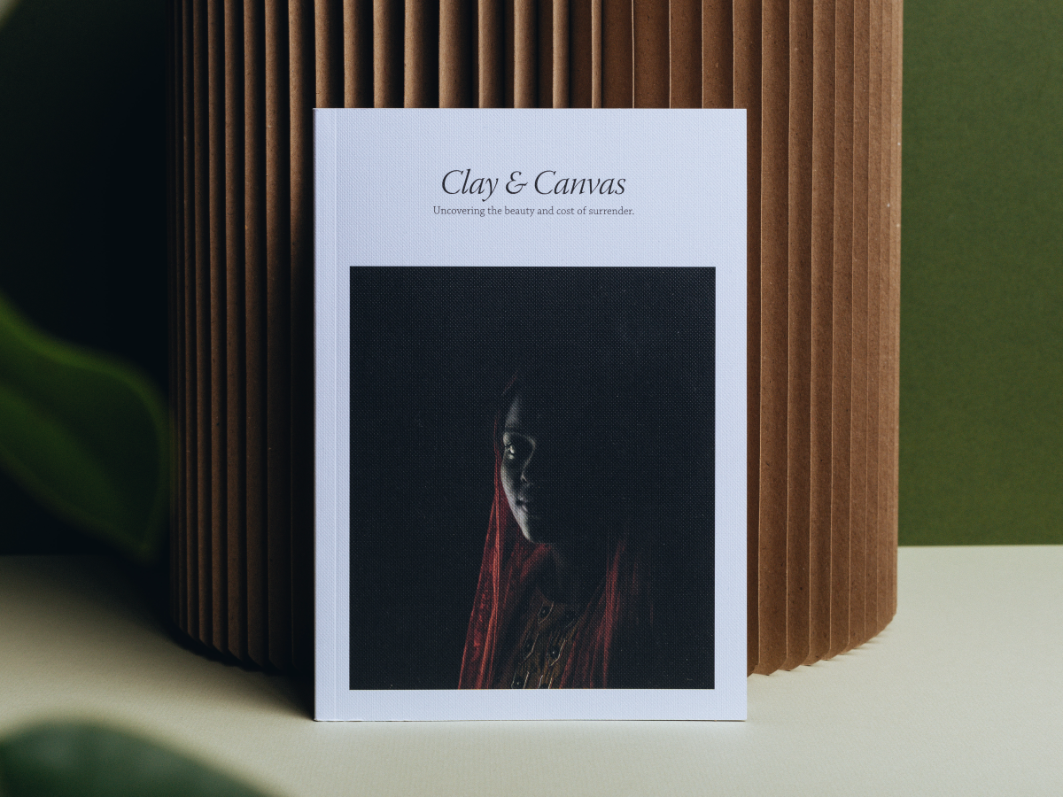 A refugee looks out from a cover photograph of a book resting upright against a cylinder