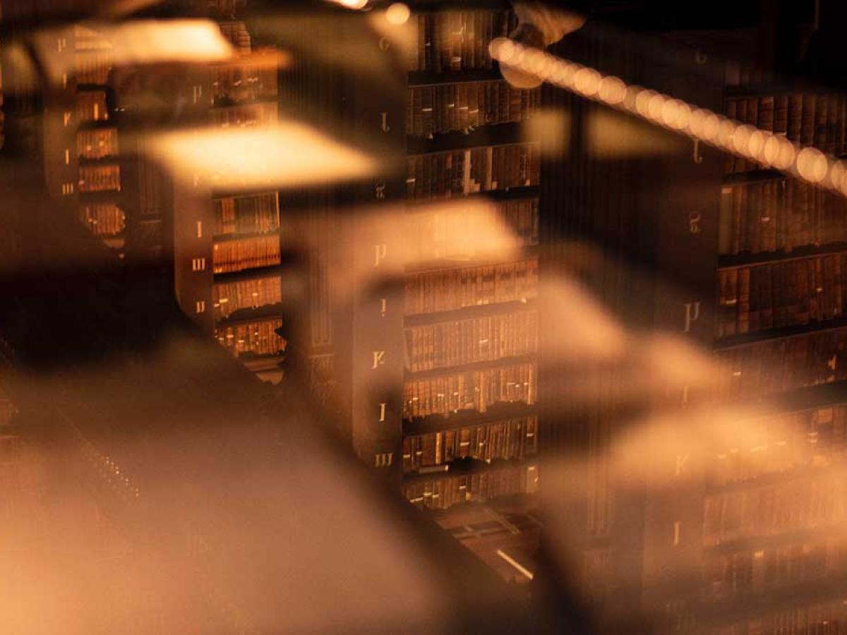 An unfocused views down on to stacks of books in an old library.