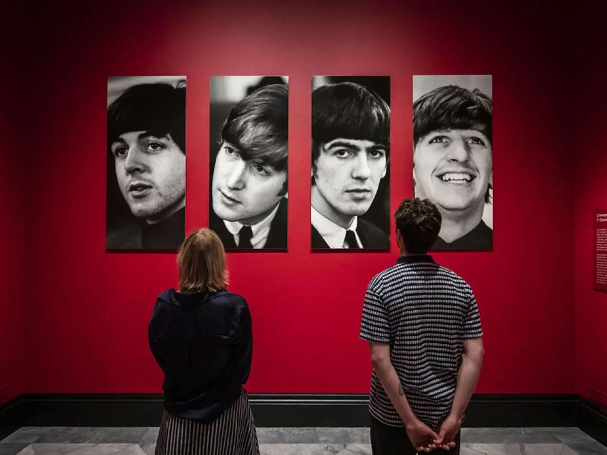 Two gallery vistor stair at four photo portraits of The Beatles.