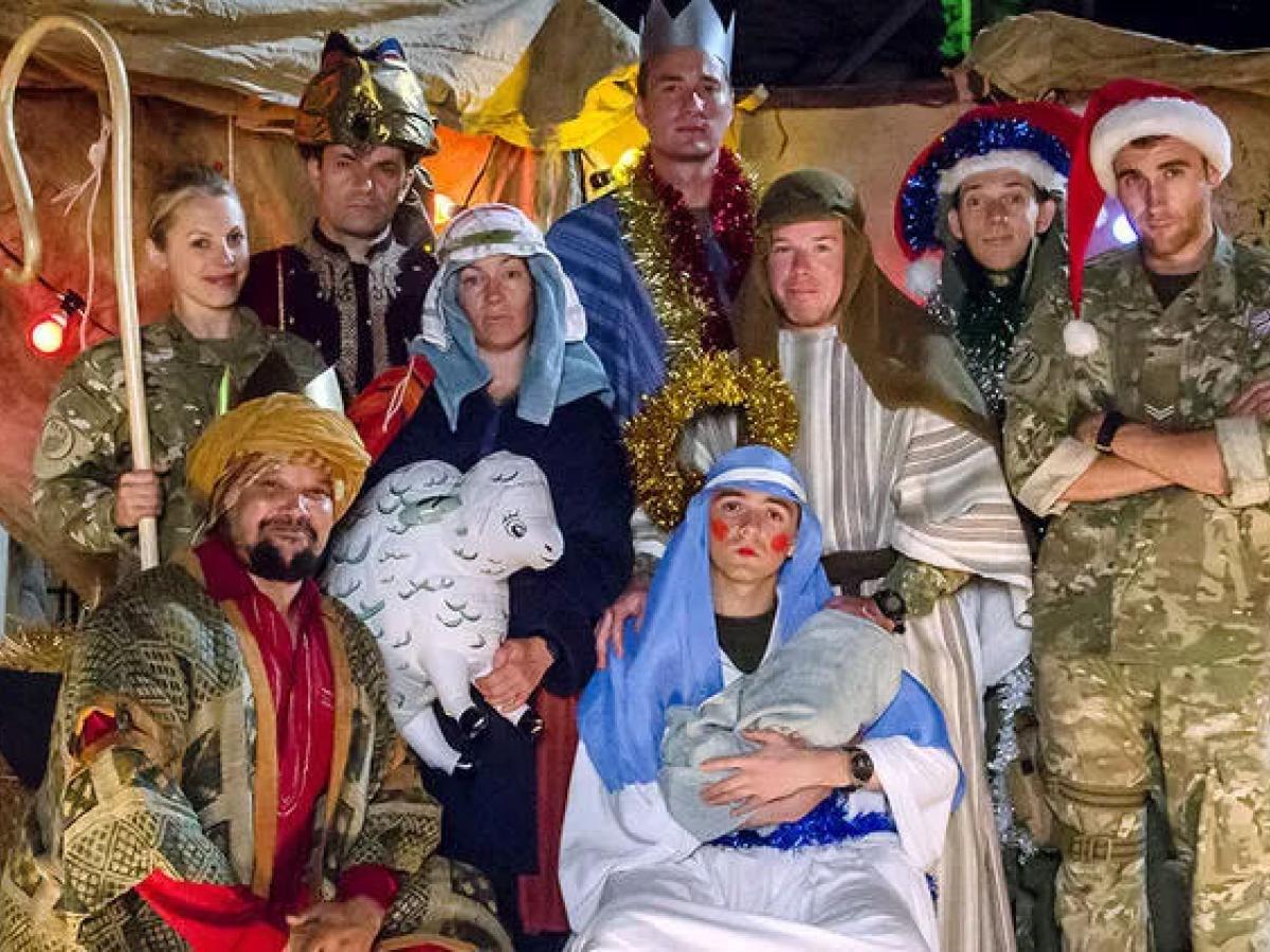 Dressed in camouflage uniforms and makeshift costumes, soldiers create a nativity scene