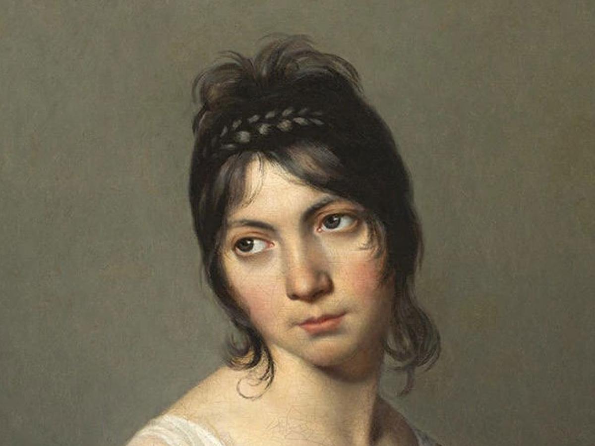 A head and shoulders portrait of a young woman inclining her gaze to one side.