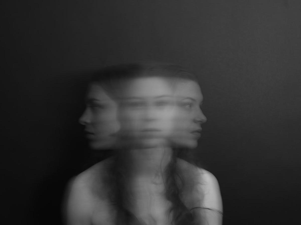 A blurred multiple exposure shows a woman turning her head from side to side.