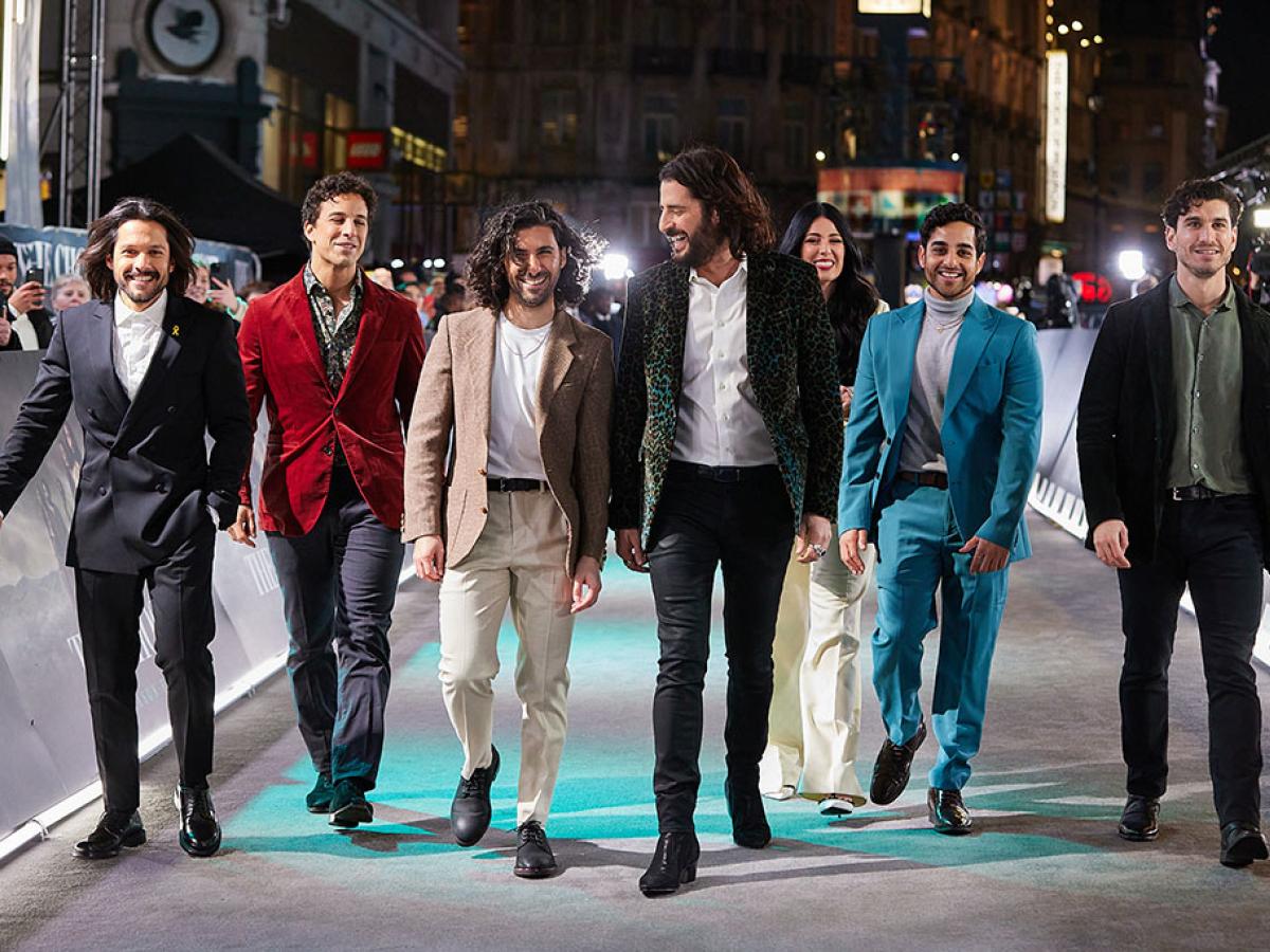 A group of actors walk together at a film premiere