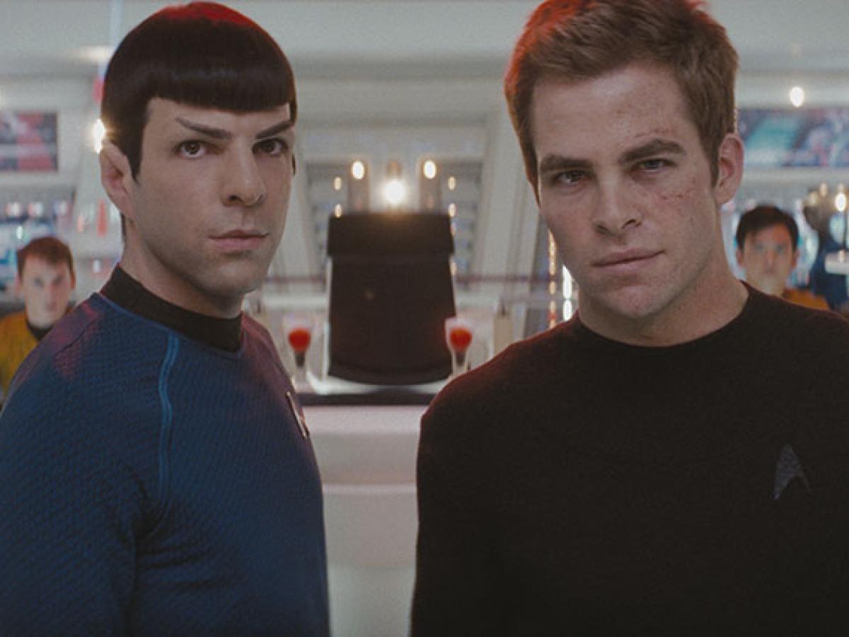 Spock and Kirk stand on the bridge of a spacecraft.