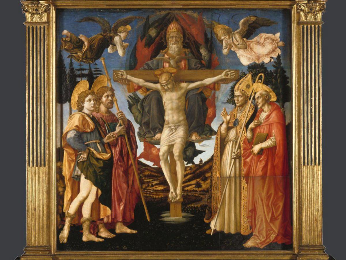 A painted altarpiece depicts a crucified Christ surrounded by followes, angels and soldiers.