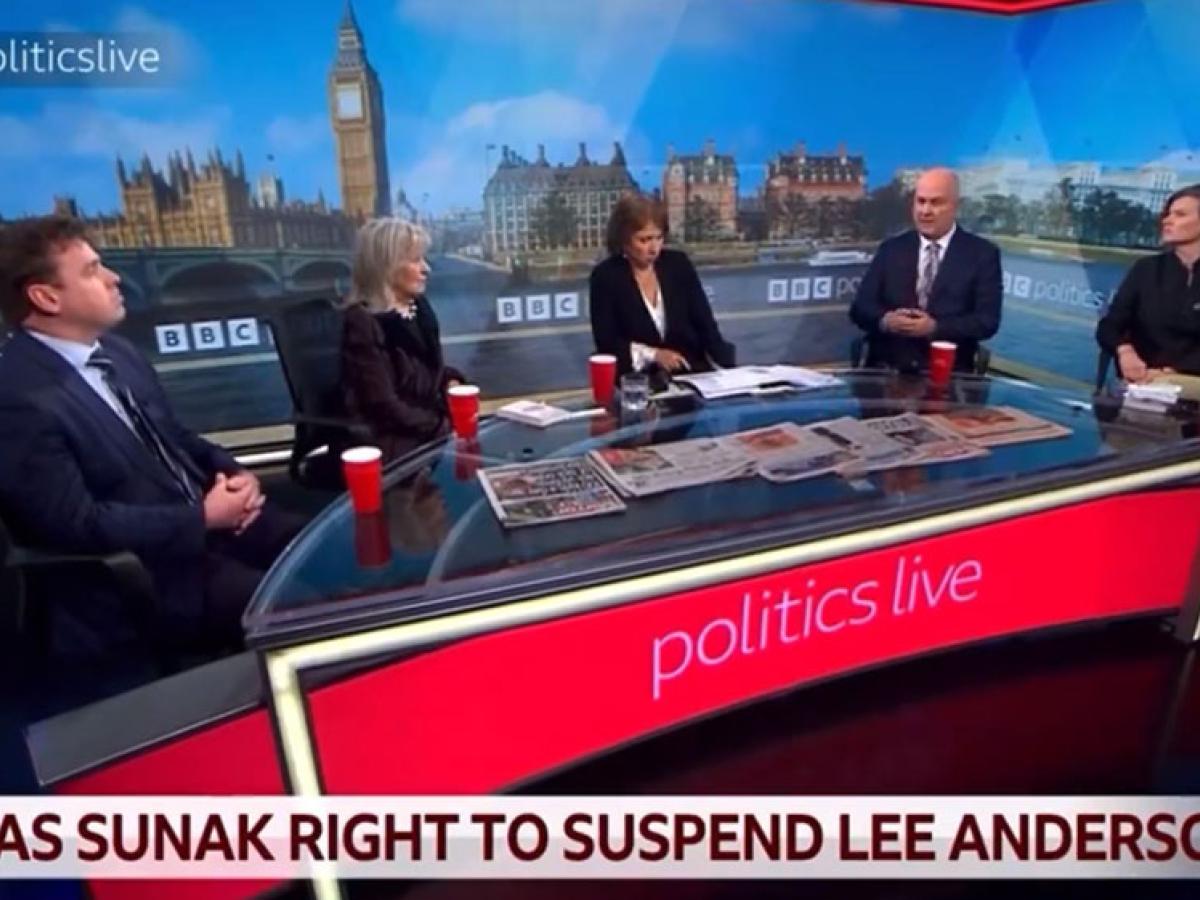 A TV roundtable discussion with five people against a backdrop of Parliament.