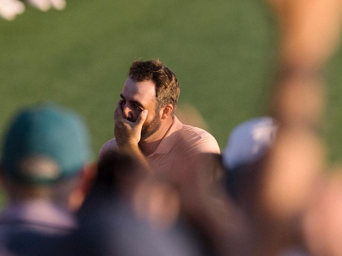 A golfer cups his face as he realises he has won.