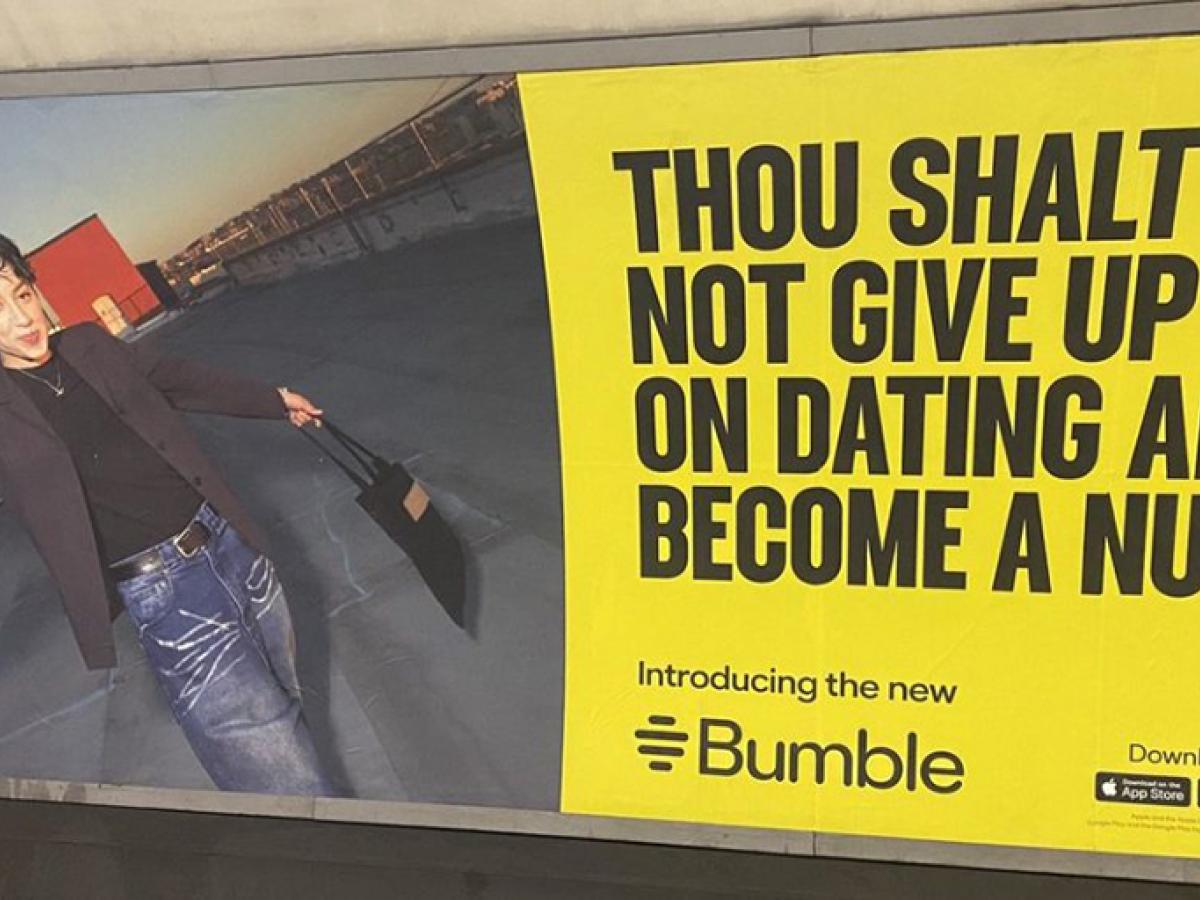 An advert on a Underground platform shows a person next to the slogna: Thou shalt not give up on dating and become a nun.