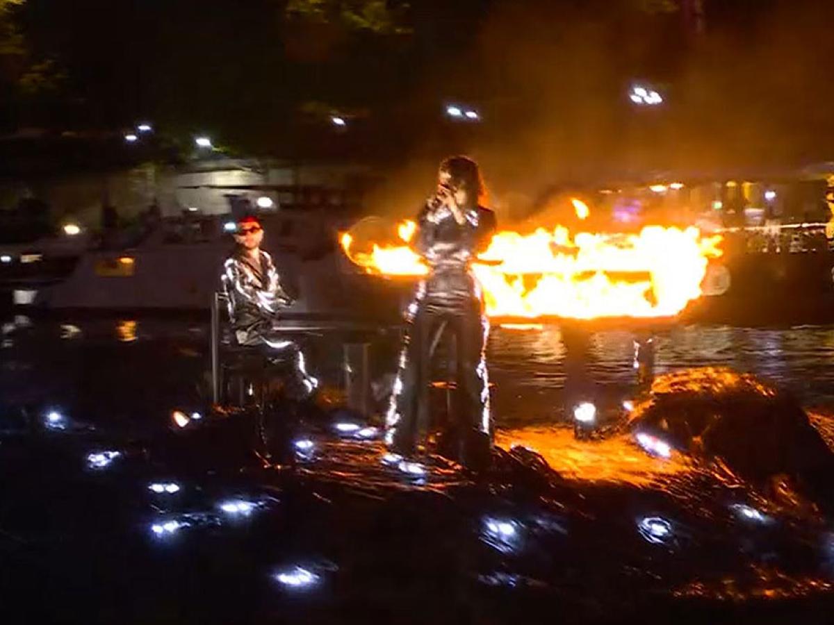 A floating stage bears a flaming piano and singer standing at a mic.