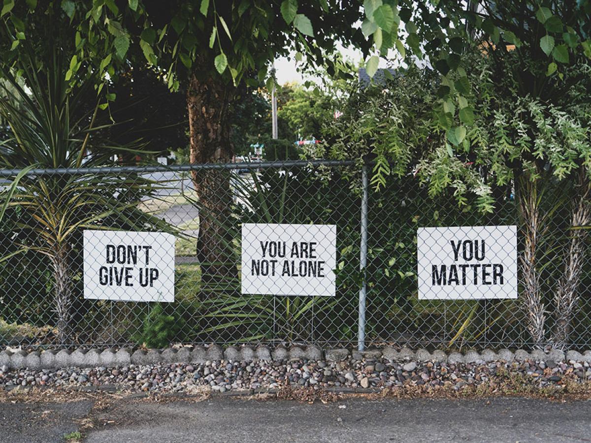 yard signs read: Don't give up. You are not alone. You matter.