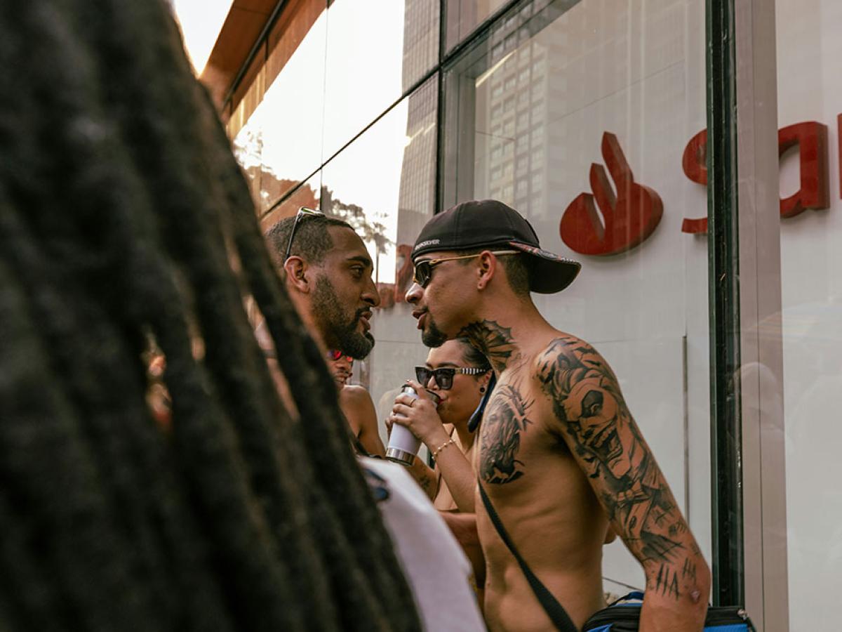 On a street, two men confront each other face to face.