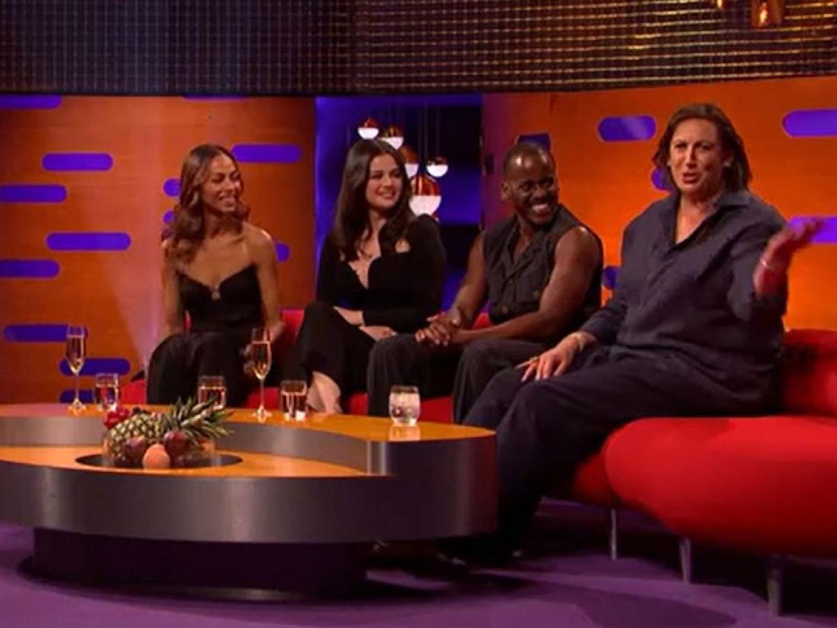 On a TV chat show, guests look to one of their own talking to the audience. 