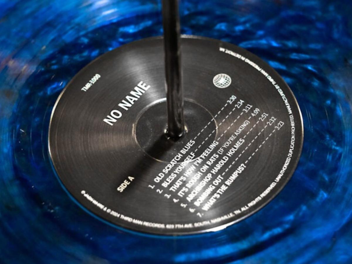 A close-up of the black label of a blue vinyl record