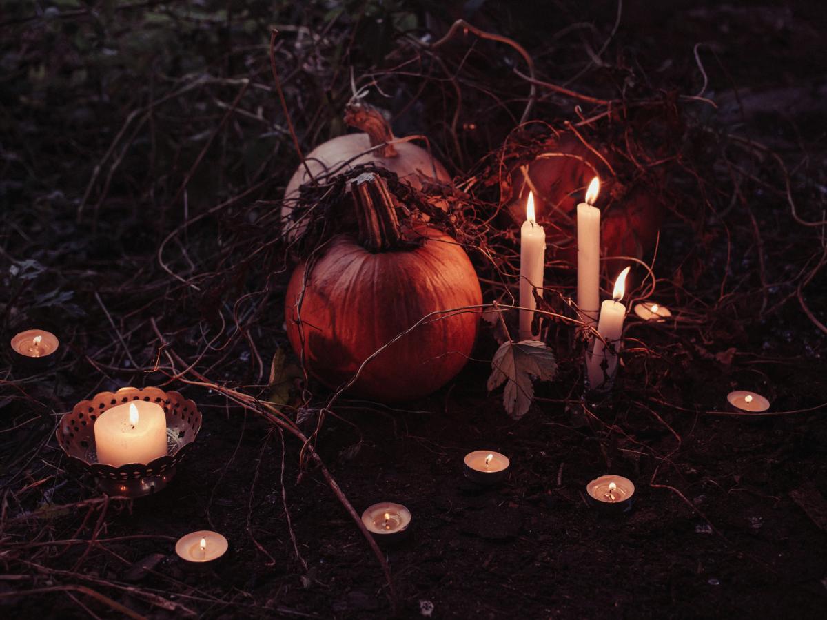 pumpkin between lighted candles