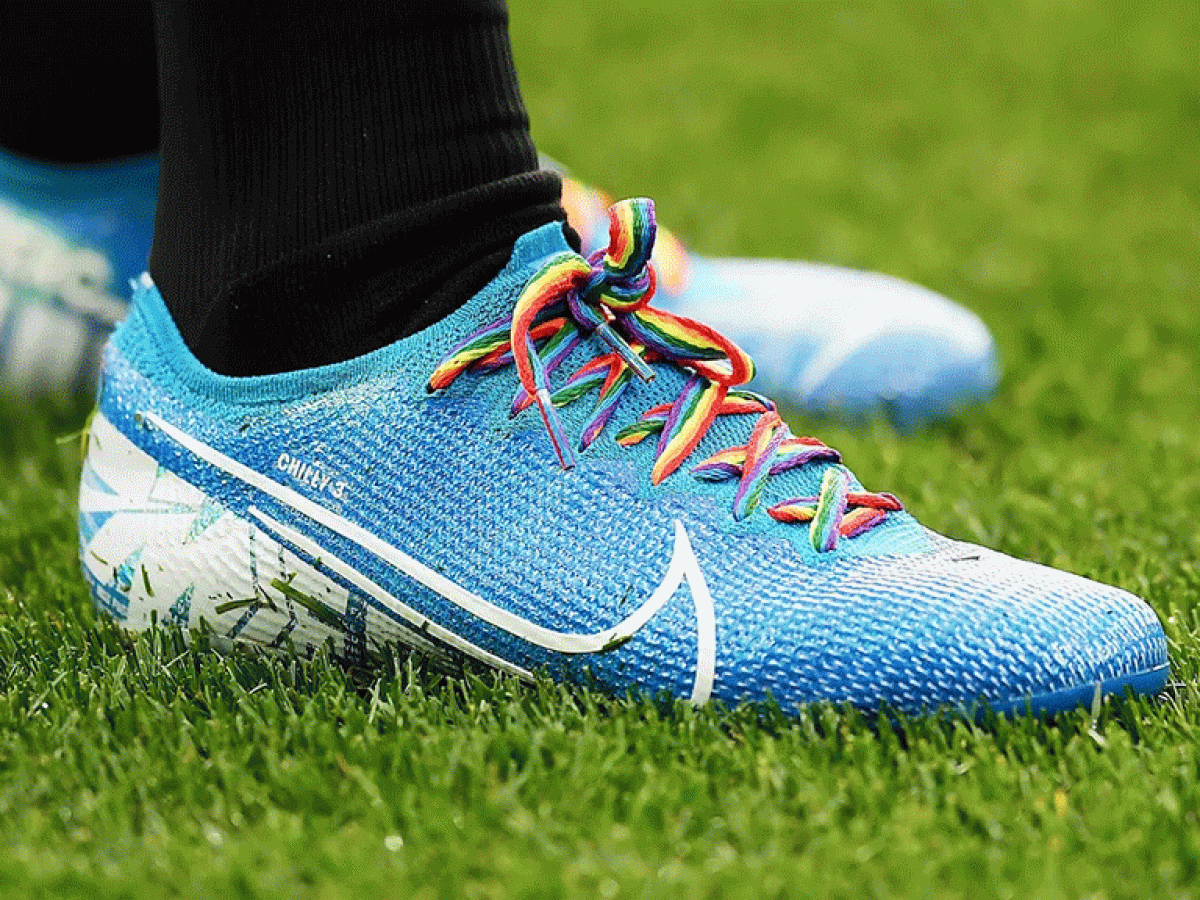 A football boot with rainbow laces