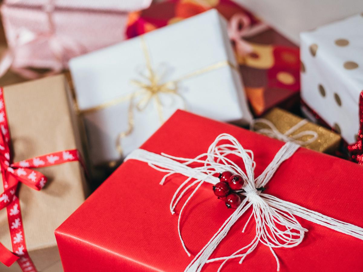 Christmas presents wrapped with red and white paper and string.