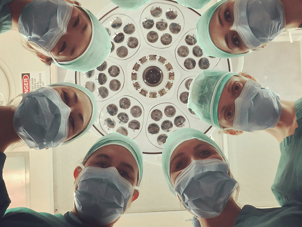 A patient eye view of six surgeons looking down.