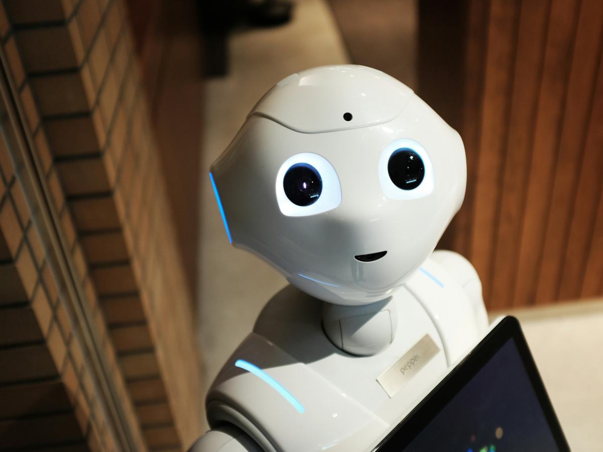 A cute-looking robot with big eyes stares up at the viewer.